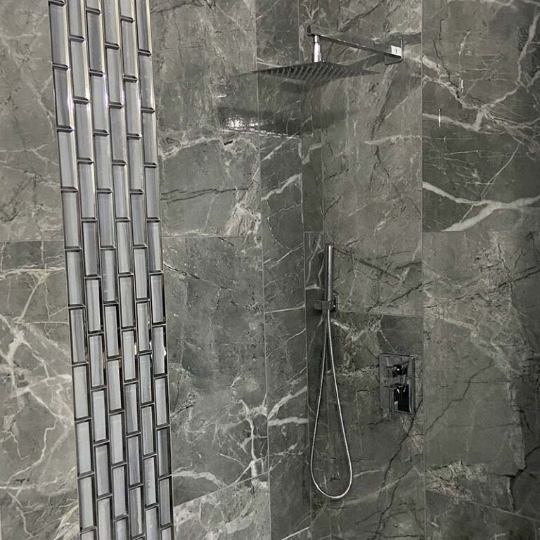modern shower remodel with grey marbled tile
